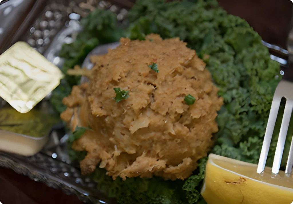 Crab cake served with lemon wedge garnish